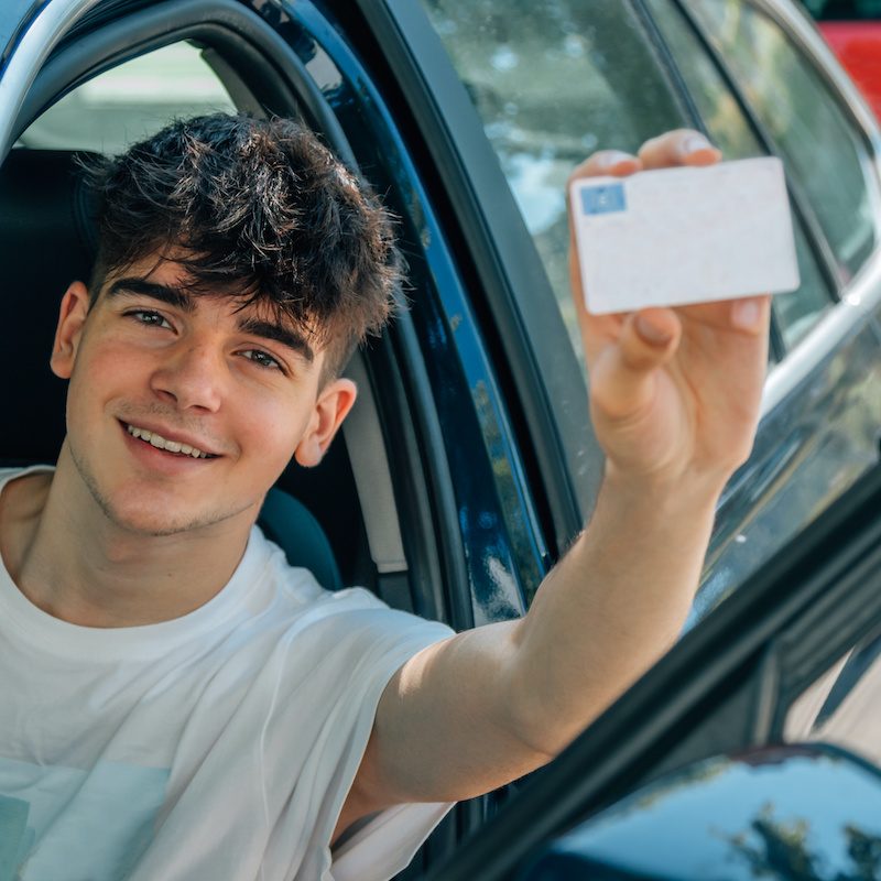 young driver in licensed car